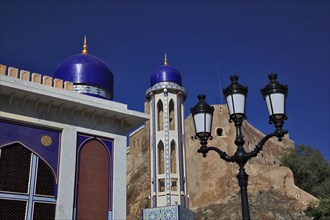 Minaret of the Masjid al-Khor Mosque and Mirani Fort in Muscat, Oman, Asia