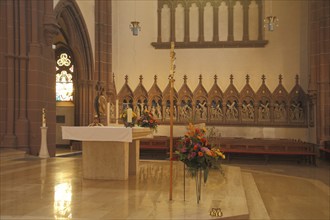 Interior view of the chancel with altar and figures row of the neo-Gothic St. Peter's Church,