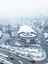 Aerial view of Kaufland, snow-covered shopping centre on a city street from a bird's eye view,