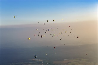 Many different hot air balloons on the way in the blue sky, distance, hot air balloon festival,