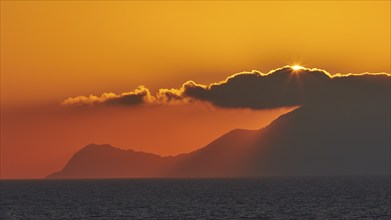 Sunset, sun disc behind clouds, Marettimo Island, Levanzo, Egadi Islands, Sicily, Italy, Europe