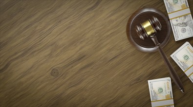 Overhead of gavel resting on a table and stacks of thousands of dollars with room for text