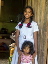 Sinhalese schoolgirl with white clothes, black braids and red ribbons, Sri Lanka, Asia