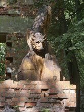 Wolf carved in wood in the ruins of the Wolf's Lair (also Wolfschanze), the military situation