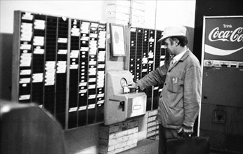 Workers and employees at the time clock of the Pohlschroeder company in Dortmund, Germany, on 01.08