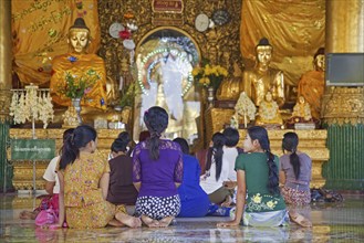 Burmese women praying barefooted in the Shwedagon Zedi Daw Pagoda at Yangon, Rangoon, former