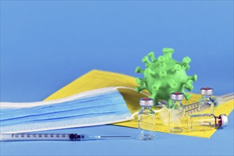 Corina virus booster vaccination concept with 4 vials and syringes, vaccination passport, virus