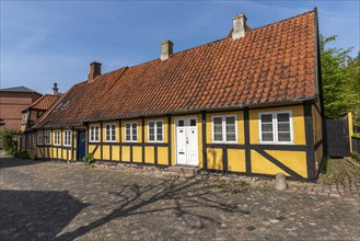 Svendborg Old Town, yellow half-timbered house, door, red roof tiles, chimneys, cobblestones, Fyn,