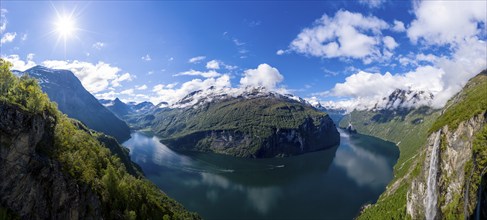 Panorama aerial view of the Geirangerfjord on a sunny spring day, waterfall Gjerdefossen, boats on