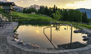 Small swimming pool in a meadow on a slope, Berchtesgaden, Bavaria, Germany, Europe