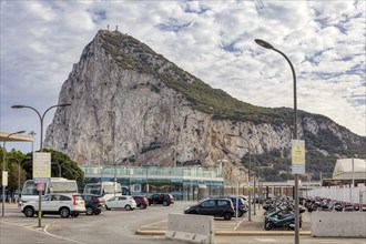 City view with prominent rock and passing cars under a cloudy sky, Gibraltar, Europe