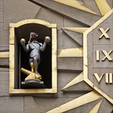 Detail of the large golden wall clock with twelve figures at the back of the Dynasty Palace,