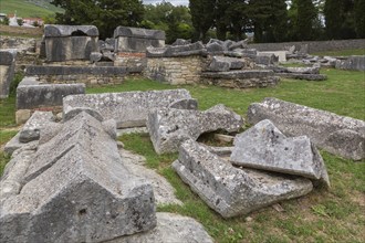 Close-up of old large and heavy broken pieces of cut and carved grey granite, stone and wall