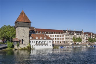 View from the old Rhine bridge to the banks of the Rhine with the historic Rhine gate tower in the