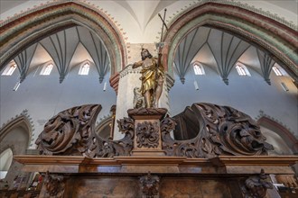 Figure of Jesus with the Lamb of God on the chancel entrance in the church of St Martin, Memmingen,