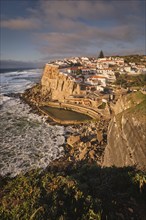 Scenic view of the seaside Azenhas do Mar fishing village on cliff on Atlantic ocean coast,