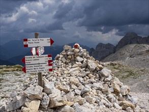 Hiking signpost, upcoming bad weather, dark clouds, dolomites, Italy, Europe