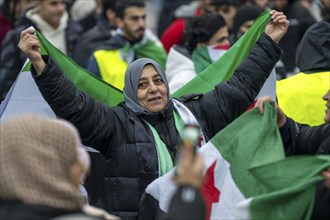 Syrian woman celebrate the end of the Assad regime after the change of power in Syria at a rally on