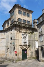 A historic building with a baroque stone façade in sunny weather, Monasterio de San Paio de