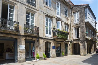 Narrow old town street lined with stone buildings with balconies, Rua Nova, Santiago de Compostela,