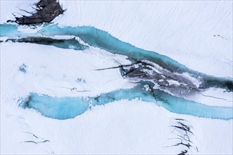 Aerial view of snow-covered high mountain landscape, melting blue ice on a lake, Norway, Europe