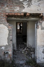 Entrance to an abandoned ruined residential building, old Soviet apartment blocks in the ghost