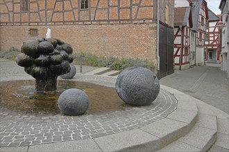 Mathildenbrunnen fountain with sculpture and balls, Butzbach, Wetterau, Hesse, Germany, Europe