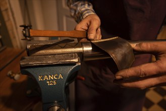 Metal instrument maker dovetails a rim blank for a trombone, Magdeburg, Saxony-Anhalt, Germany,