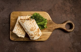 Cut shawarma, 2 pieces, on a cutting board, close-up