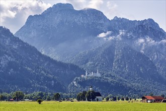 Neuschwanstein Castle in the morning mist, pilgrimage church of St Coloman, summer, Tegelberg,