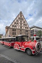 Tourist train passes the medieval toll hall, Nuremberg, Middle Franconia, Bavaria, Germany, Europe