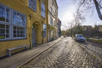 Street An der Obertrave, cobblestone pavement, historic buildings, backlight and sidelight of the