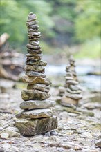 Balanced piles of stones on the riverbank in nature