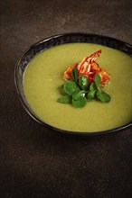 Pea cream soup, with shrimp, green soup, homemade, top view, no people