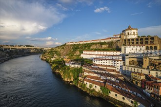 View of Vila Nova de Gaia city with Mosteiro da Serra do Pilar monastery and Douro river on sunset.