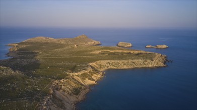 Drone shot, near Acropolis of Lindos, late afternoon light, drone shot of a remote island with