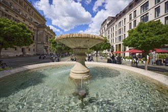 Fountain on the Opera Square under a blue sky with cumulus clouds in the city centre of Frankfurt