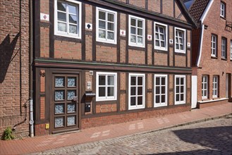 Façade with door and windows of a half-timbered house in Stade, Hanseatic city, district of Stade,