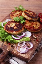 Fried chicken cutlets, minced chicken, with vegetables, on a cutting board, with vegetable salad,