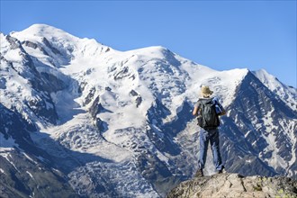 Mountaineer in front of the glaciated summit of Mont Blanc, Mont Blanc massif, Aiguilles Rouges,