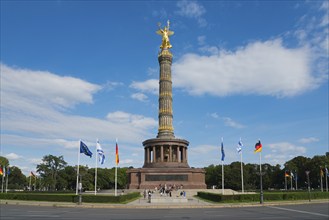 The Berlin Victory Column with golden statue and international flags in the foreground, Victory