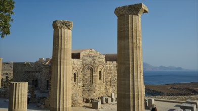 Ruins of an ancient site with columns and a view of the sea under a clear blue sky, Acropolis of