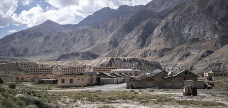 Abandoned ruined buildings in a mountain landscape, ghost town, Engilchek, Tian Shan, Kyrgyzstan,