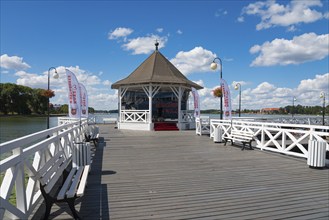 Wooden jetty with pavilion at the lake under a blue sky with white clouds, Drawenzsee, Jezioro