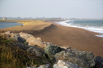 North Sea coastline view of rock armour and beach bar north to Shingle Street, East Lane, Bawdsey,