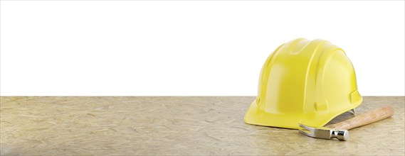 Yellow construction hard hat and hammer resting on particleboard banner isolated on a white