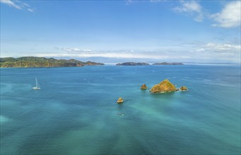 Aerial view, tropical islands and sailing boat in the turquoise ocean, Tortuga Island, Puntarenas,