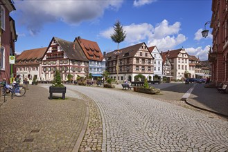 Market square with maypole, bus stop Gengenbach town hall and half-timbered houses in Gengenbach,