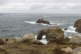 Large rocks and cliffs by the sea, rough seas and grey skies, Land's End, Cornwall, Great Britain