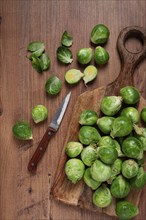 Fresh Brussels sprouts, raw, top view, on a wooden table, no people